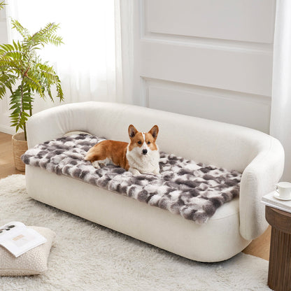 Dog lying on a tie-dye grey couch cover on a white couch in a bright room.#color_Tie-dye Grey
