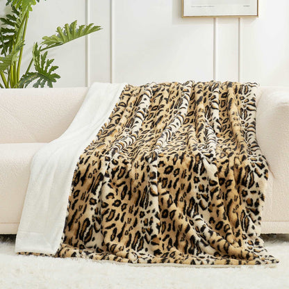 Leopard print faux fur throw blanket draped over a couch, showcasing soft, cozy texture for home decor. #color_Brown Leopard