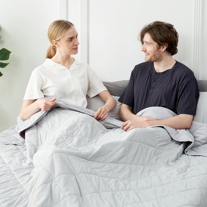 Couple relaxing under a soft, cooling blanket, ideal for cozy sleep and hot sleepers. #Color_Cool Grey