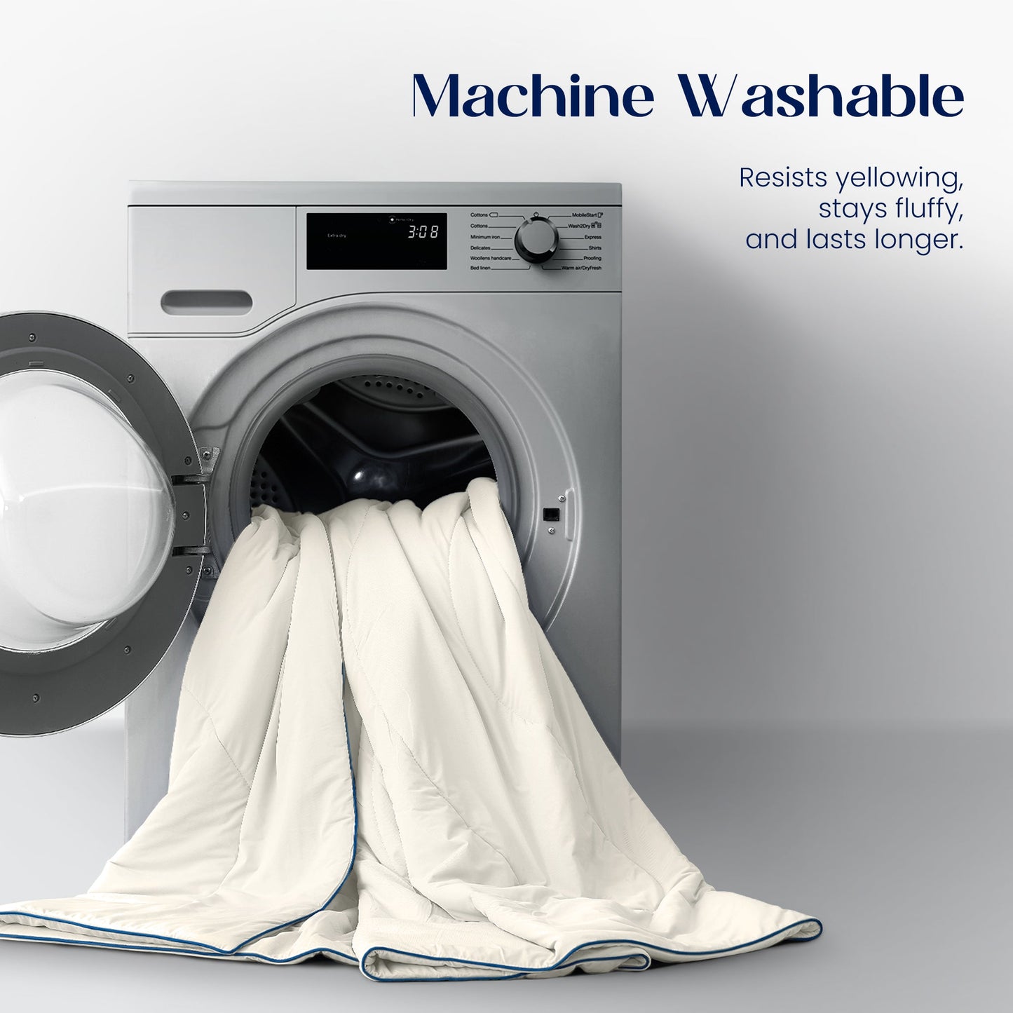 White comforter being put into a washing machine with text about machine washability.#color_Ivory