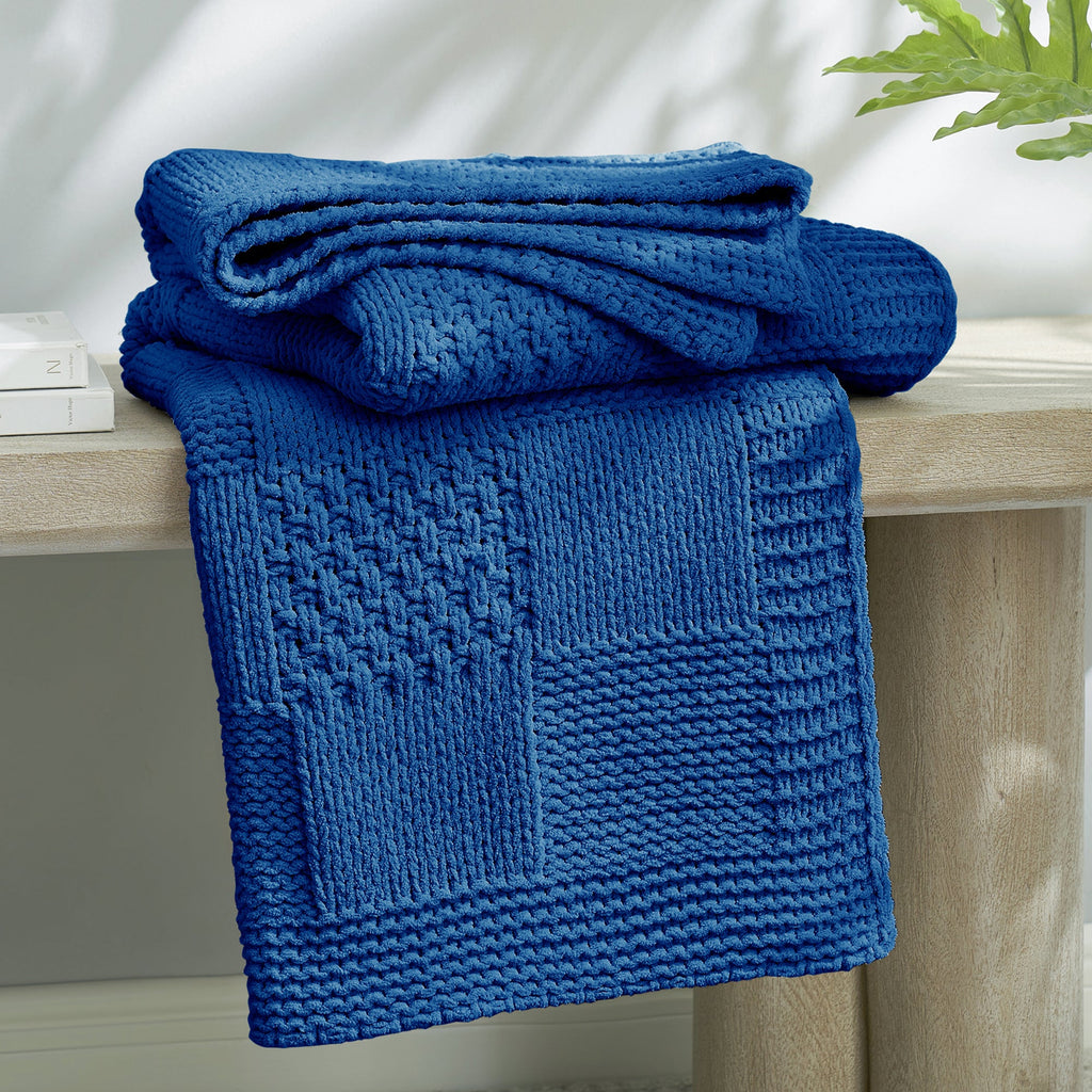 Checkered Chenille Knit Throw Blanket in Blue neatly folded on a table, showcasing detailed knit texture and soft chenille fabric. #color_Blue