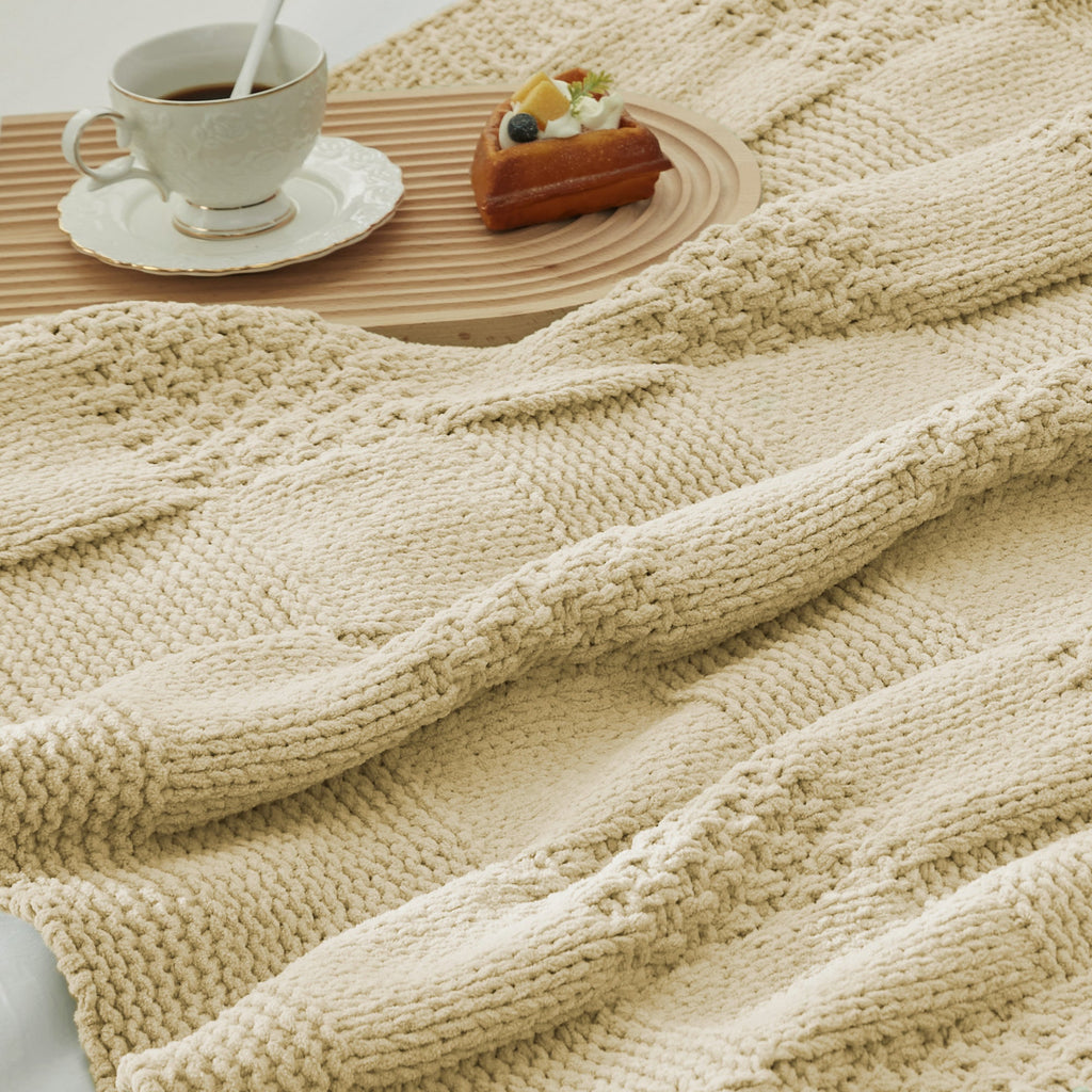 Close-up of Checkered Chenille Knit Throw Blanket in Beige showcasing textured chenille knit pattern with a cozy tea and dessert setting. #color_Beige
