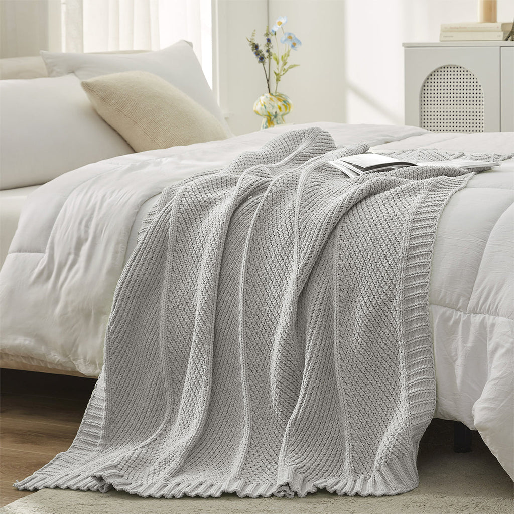 Chevron Chenille Knit Throw Blanket in Light Grey styled on a bed, adding a clean and modern layered look. #color_Light Grey