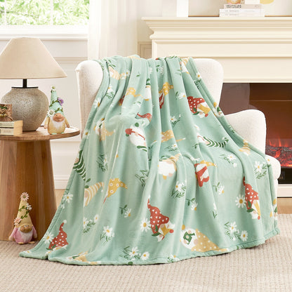 Spring gnomes milkyplush throw blanket in Green draped over a chair, creating a soft and cozy spring atmosphere #color_Green