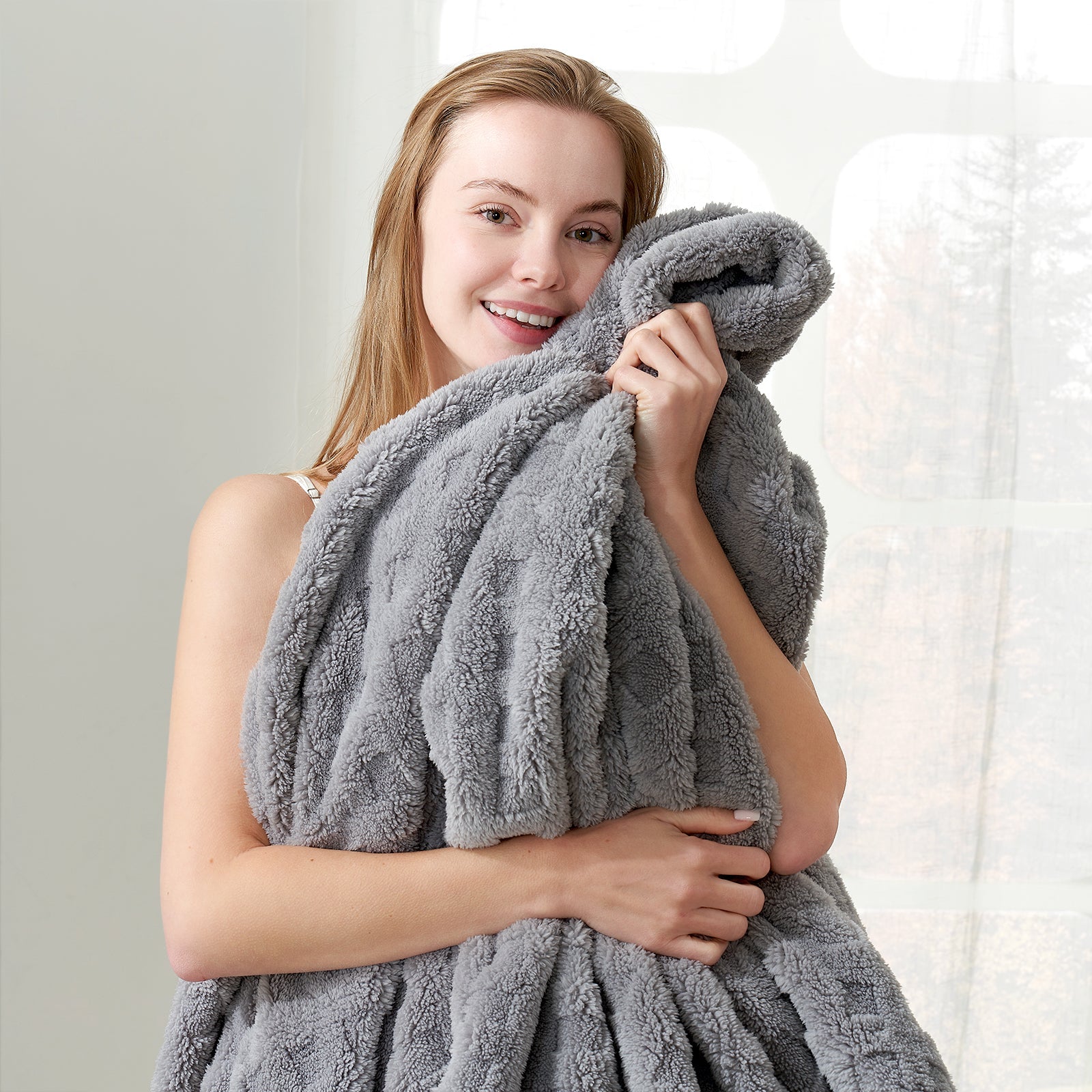 Woman holding a checkered waffle shaggy sherpa throw blanket in Light Grey, enjoying soft and cozy comfort #color_Grey