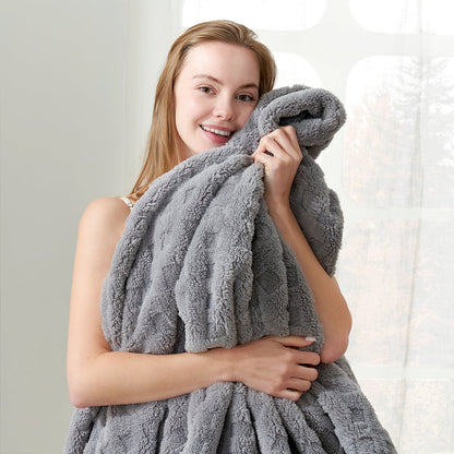 Woman holding a checkered waffle shaggy sherpa throw blanket in Light Grey, enjoying soft and cozy comfort #color_Grey
