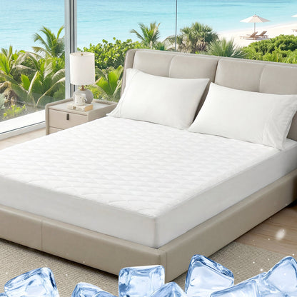 Bed with white mattress cover and pillows in a room with a view of greenery. #color_Off White