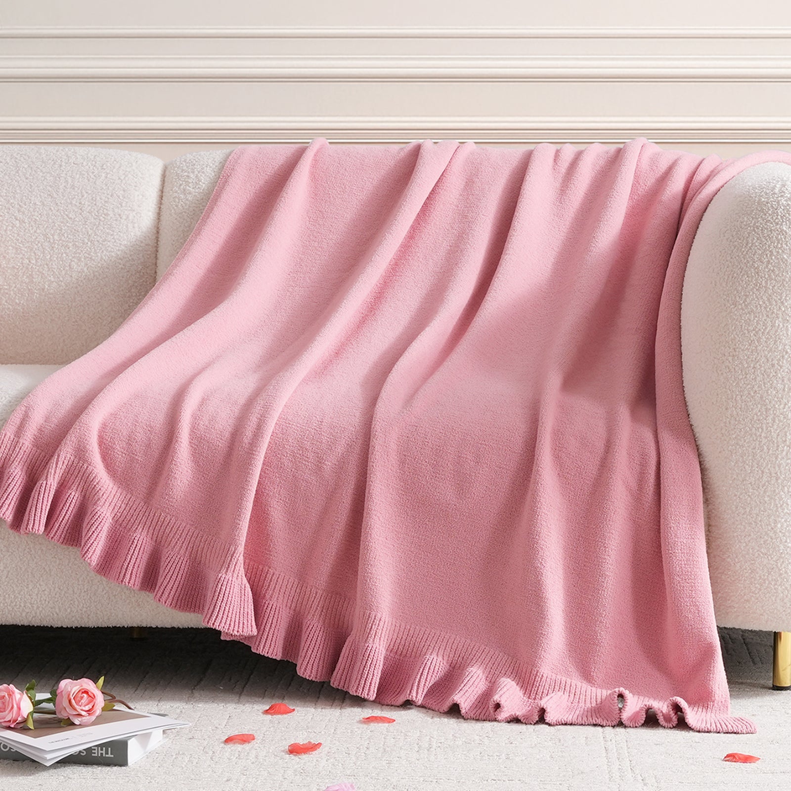 Ruffle Knit Chenille Throw Blanket in Pink draped over a sofa, showcasing soft chenille texture and ruffle edge design in a cozy living room setting. #color_Pink