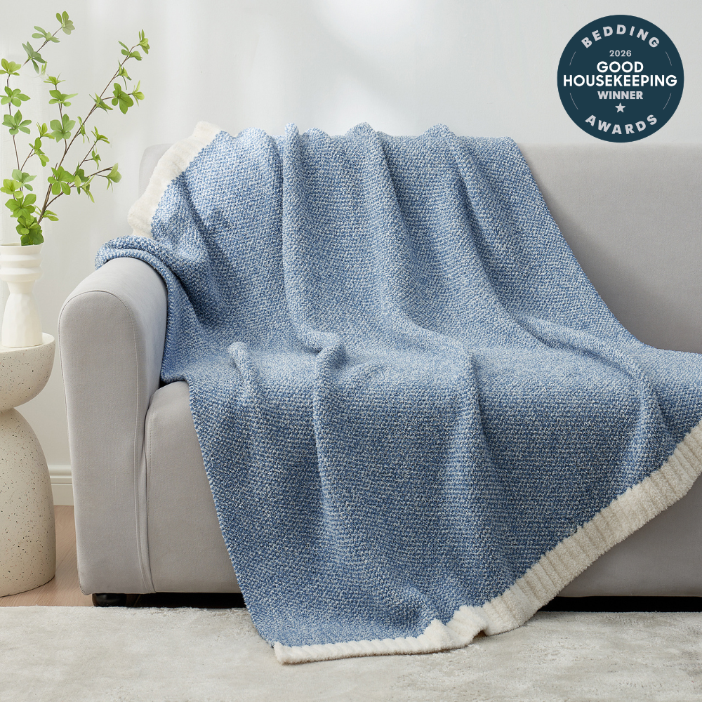 Heather Feather Yarn Throw Blanket in pale blue draped over a sofa, adding warmth, softness and a modern cozy touch to your living room. #Color_Pale Blue