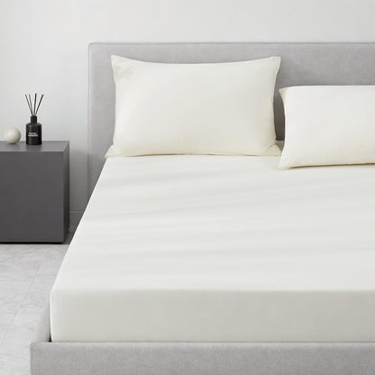 Gray cooling bedding set on a bed in a minimalistic bedroom setting.#color_Ivory