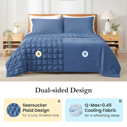 Blue quilt with seersucker plaid and Q-Max cooling fabric on a bed in a bedroom setting. #color_Dark Blue
