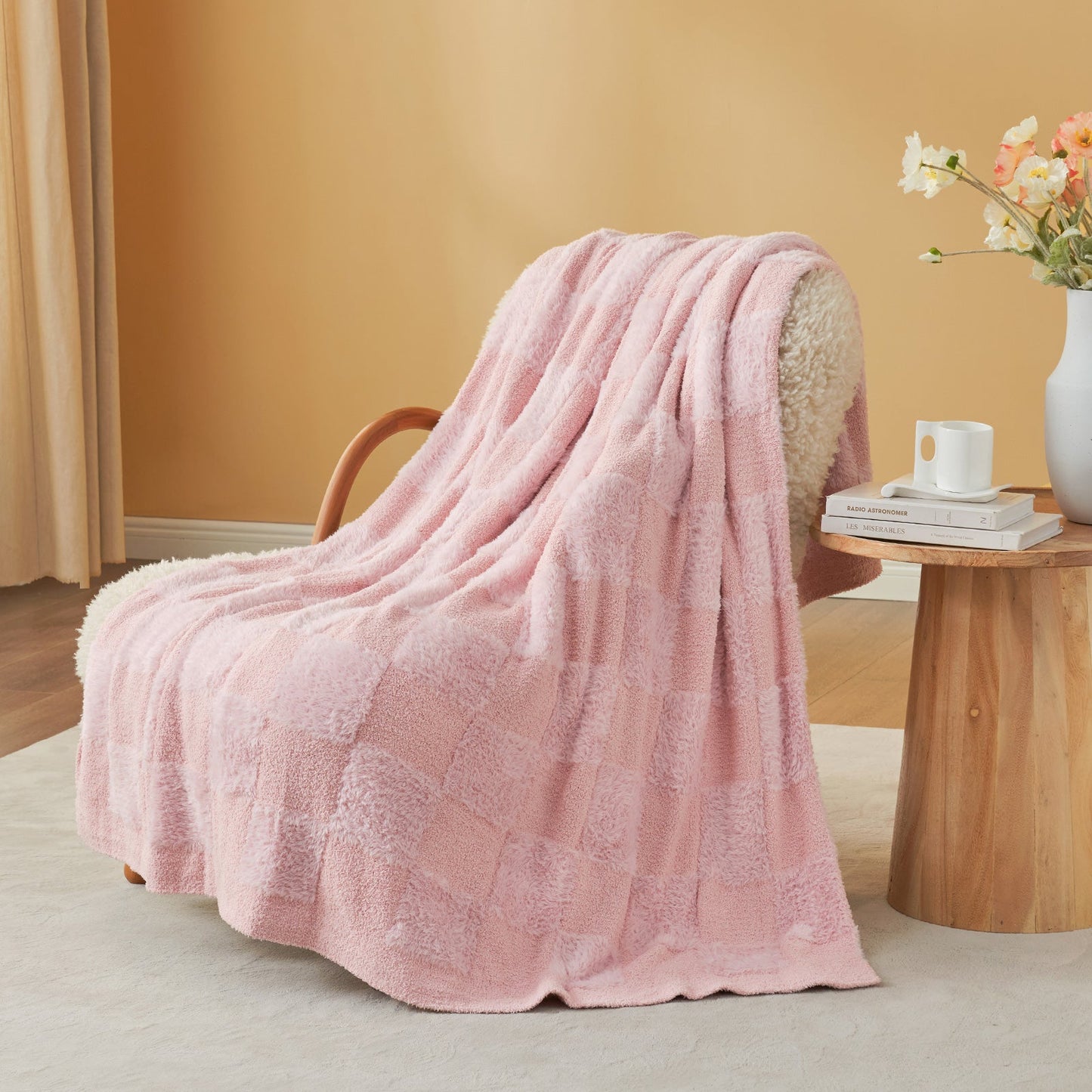 Checkered Faux Fur Feather Yarn Throw Blanket in Pink draped over an armchair, adding a soft and cozy vibe. #color_Pink