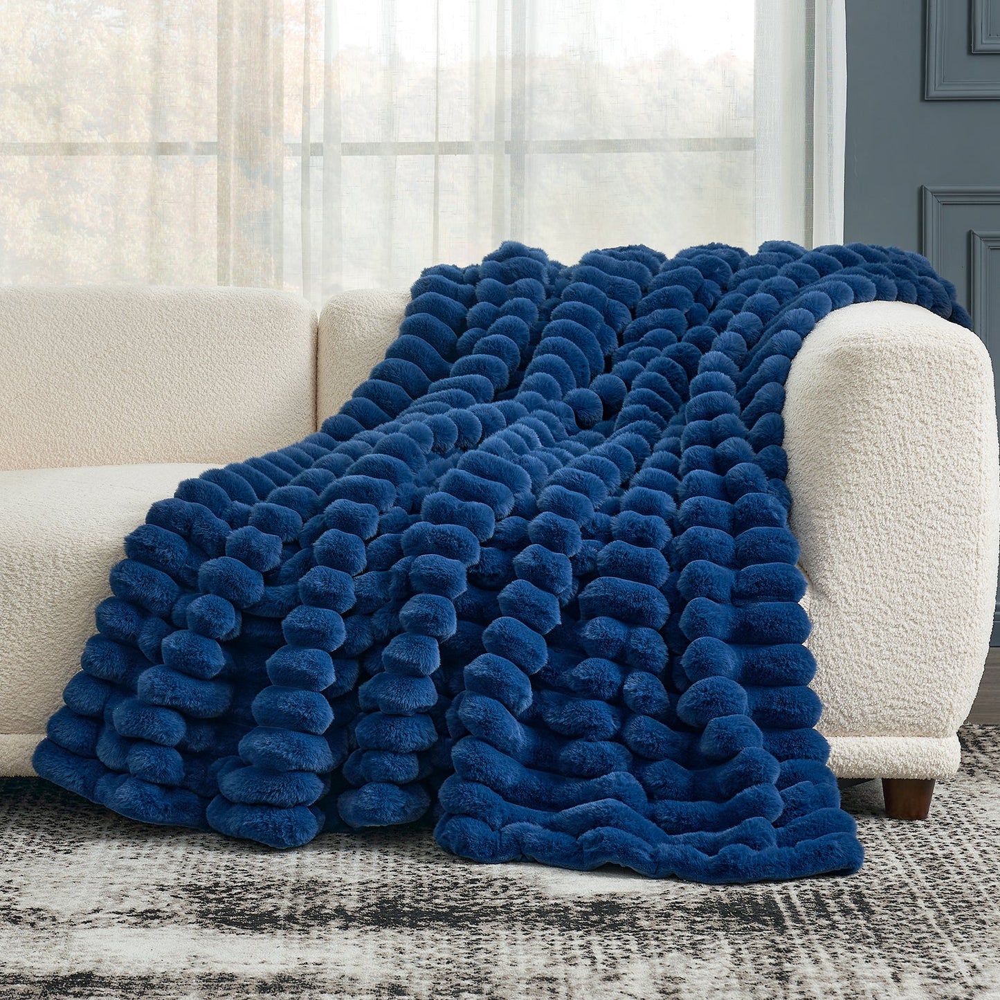 Cozy Bliss navy blue striped faux fur throw blanket draped on a sofa, offering cozy comfort and stylish design. #color_Navy Blue