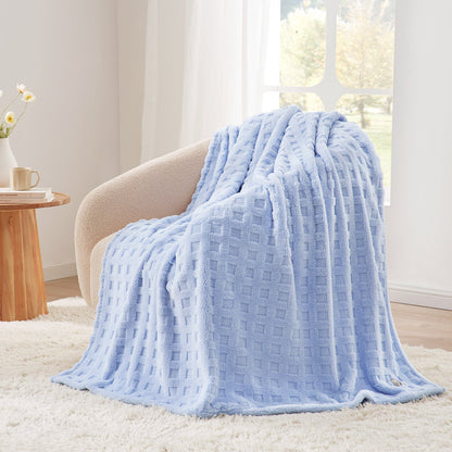 Checkered waffle shaggy sherpa throw blanket in Blue draped over an armchair, creating a clean and cozy corner #color_Cool Blue