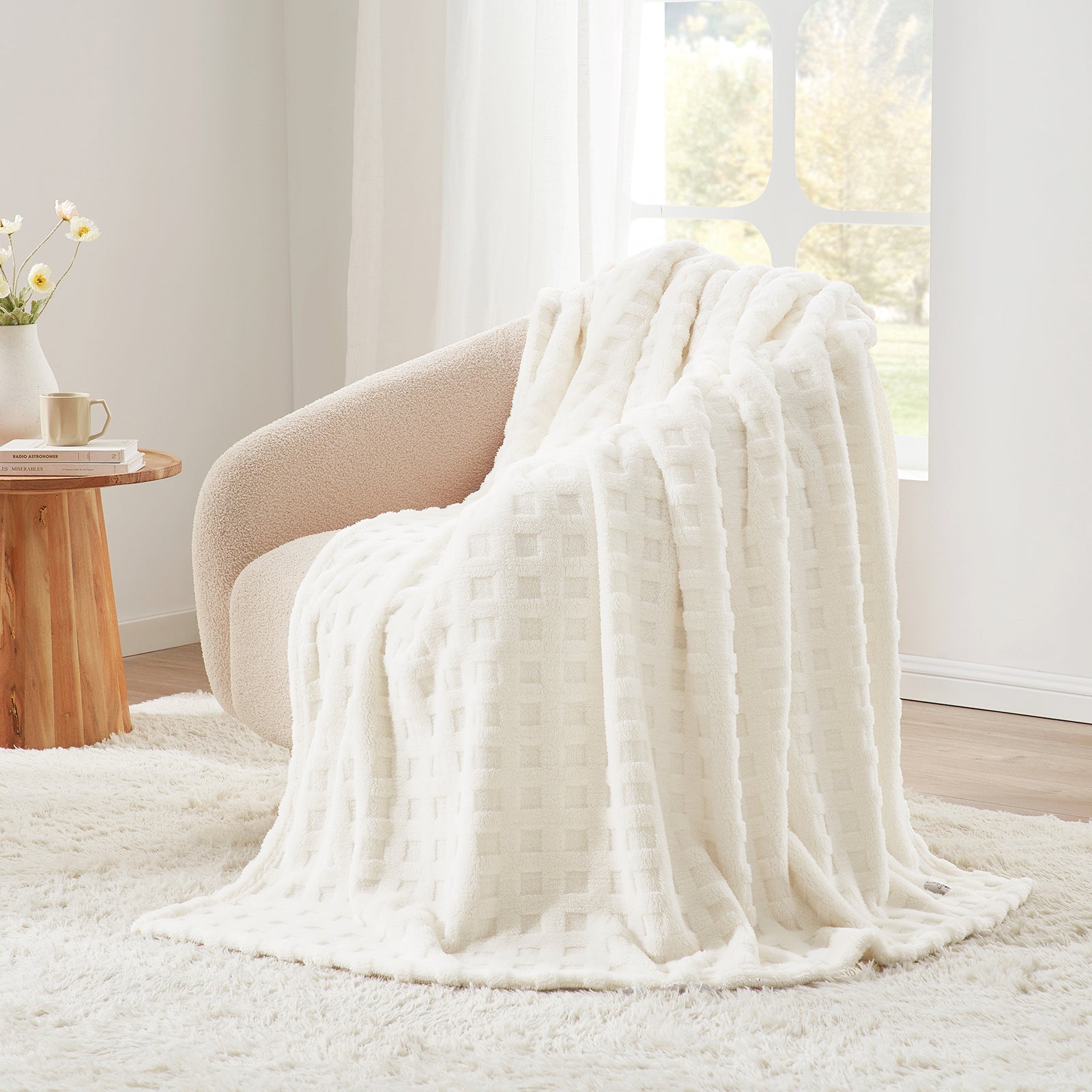 Checkered waffle shaggy sherpa throw blanket in Ivory draped over an armchair, creating a clean and cozy corner #color_Ivory