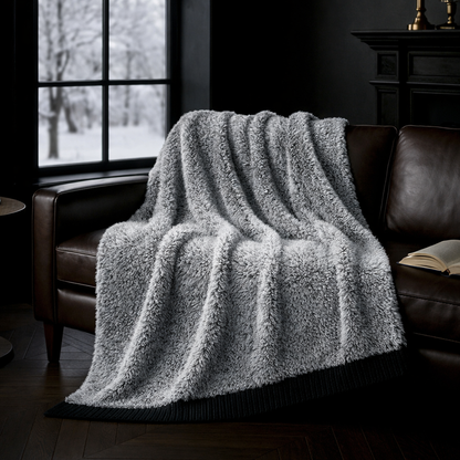 Faux Mink Feather Knit Throw Blanket in Black draped over a sofa in a cozy living room setting, highlighting plush texture and warmth. #color_Black