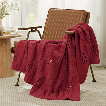 Chenille Cable Knit Throw Blanket in Red front view draped over an armchair, showcasing rich color and soft cable knit texture. #color_Red
