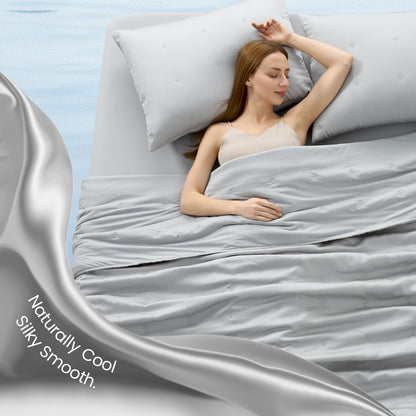 Woman sleeping peacefully under grey silky smooth Tencel™ lyocell cooling comforter.#Color_Grey