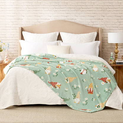 Spring gnomes milkyplush throw blanket in Green layered on a bed, creating a warm and playful bedroom look #color_Green