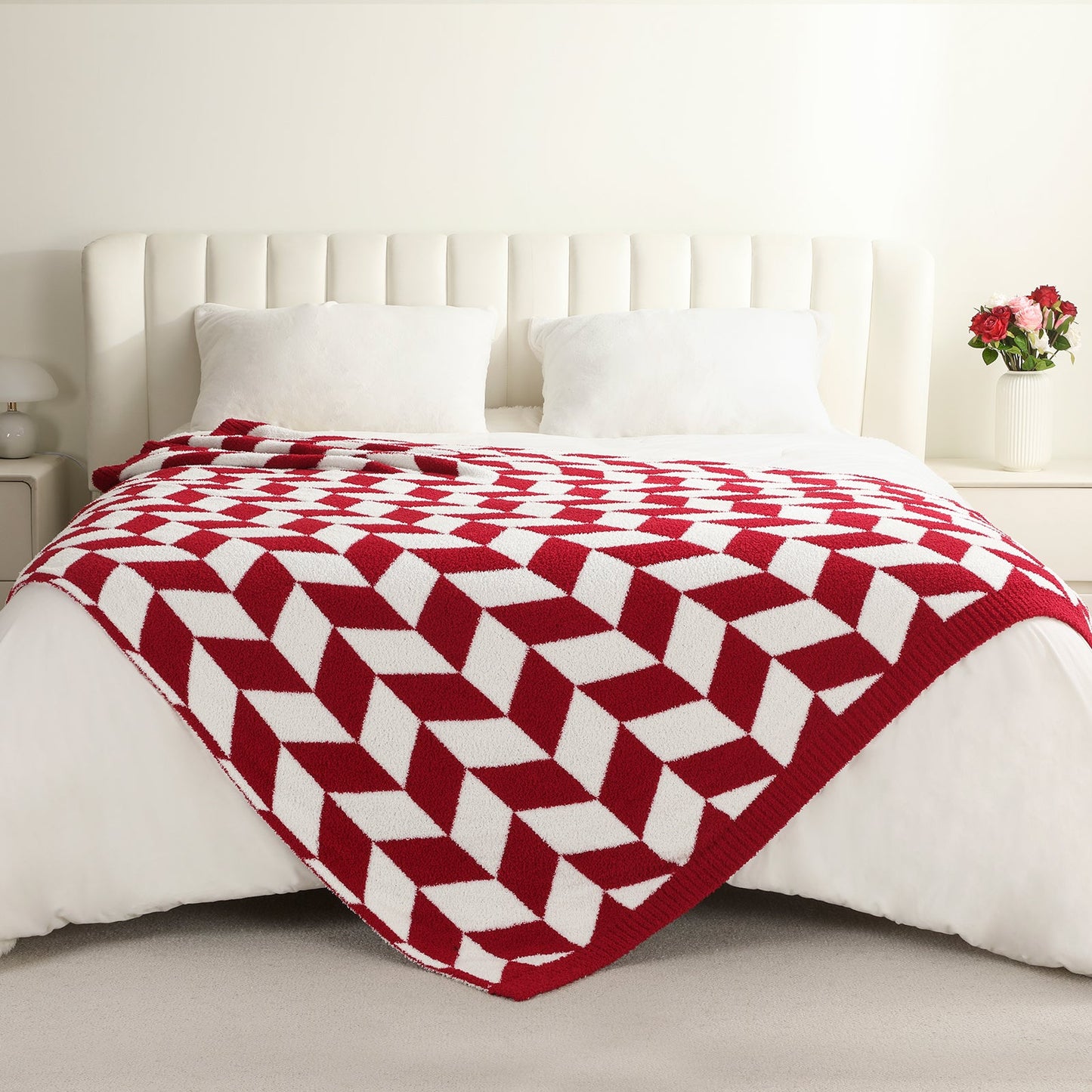 Chevron Feather Yarn Knit Throw Blanket in Red styled on a bed, highlighting soft texture and modern chevron pattern in a bright bedroom setting. #color_Red