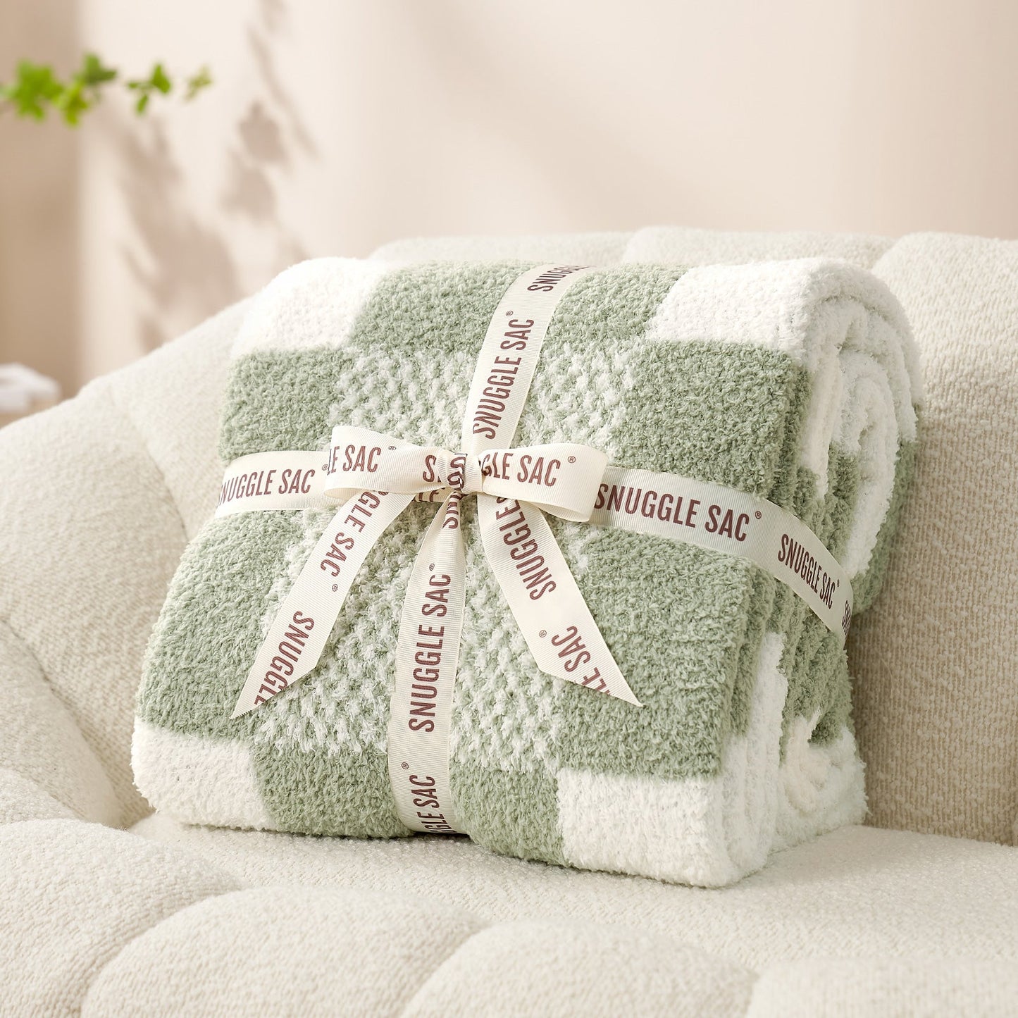 Checkered Feather Yarn Throw Blanket in Sage Green & White neatly folded as gift packaging, perfect for holidays and special occasions. #color_Sage Green & White
