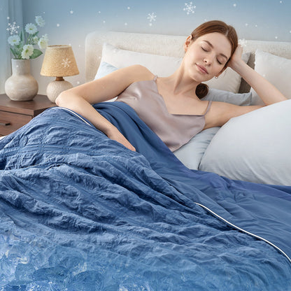 Woman waking up refreshed with Cozy Bliss dark blue seersucker plaid cooling comforter.#color_Dark Blue