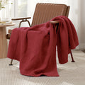 Checkered Chenille Knit Throw Blanket in Red draped over a lounge chair, showcasing soft chenille knit texture and cozy checkered design. #color_Red