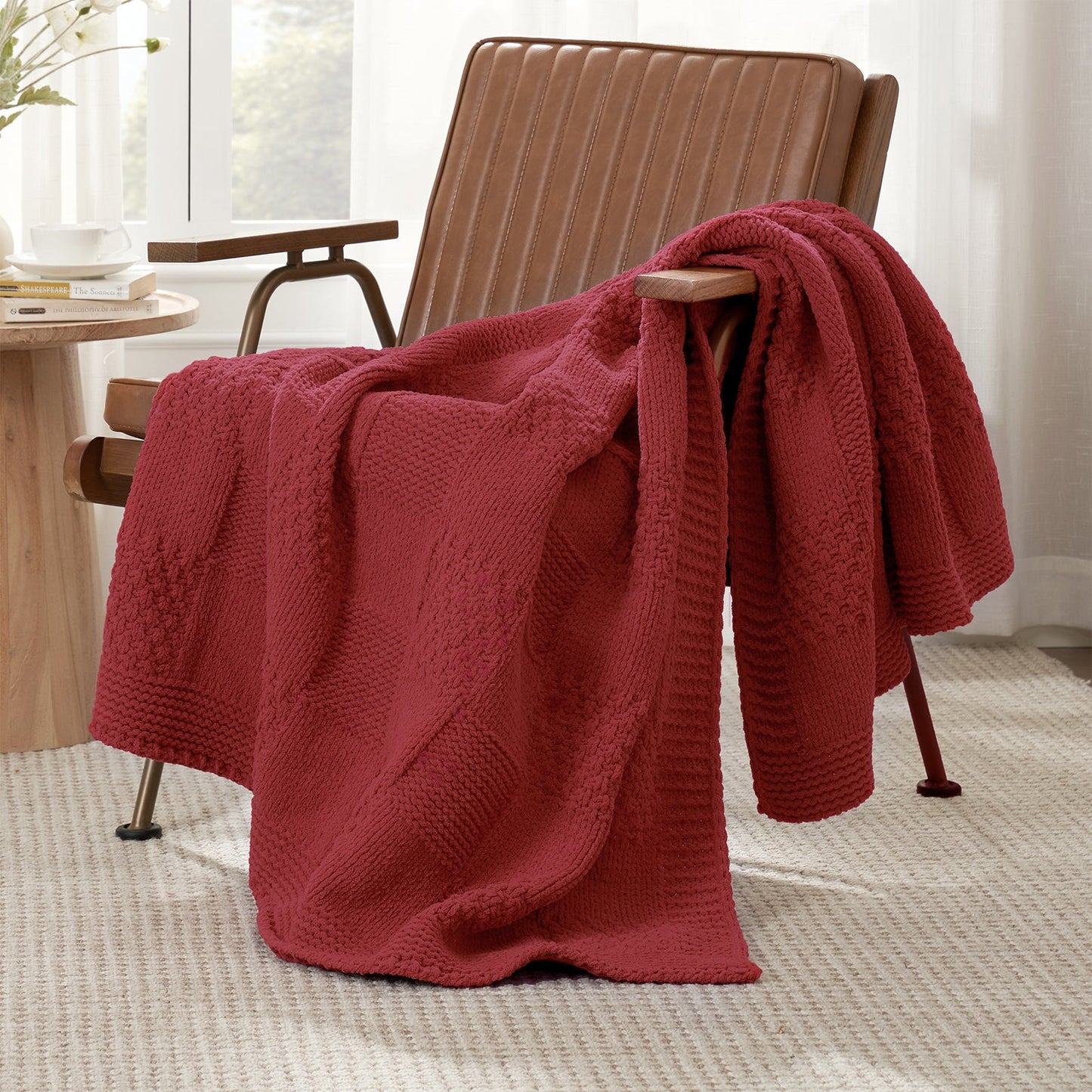 Checkered Chenille Knit Throw Blanket in Red draped over a lounge chair, showcasing soft chenille knit texture and cozy checkered design. #color_Red