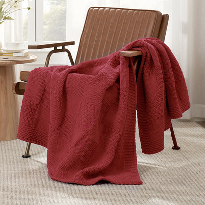 Checkered Chenille Knit Throw Blanket in Red draped over a lounge chair, showcasing soft chenille knit texture and cozy checkered design. #color_Red