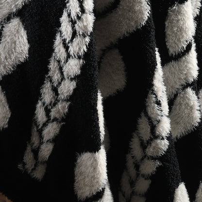 Close-up of cable knit pattern on Faux Mink Cable Knit Throw Blanket in Black highlighting soft faux mink fibers and textured design. #color_Black