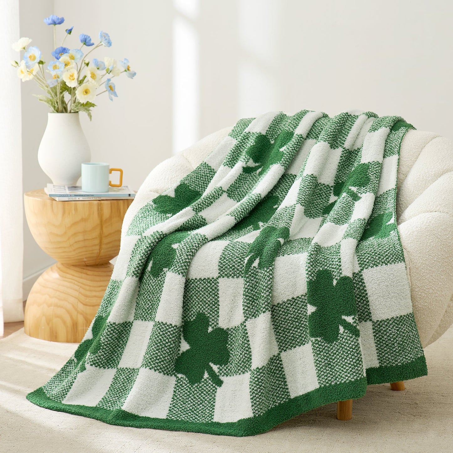 Green and white checkered blanket with shamrock pattern draped over a sofa in a cozy living room. #color_Lucky Clover