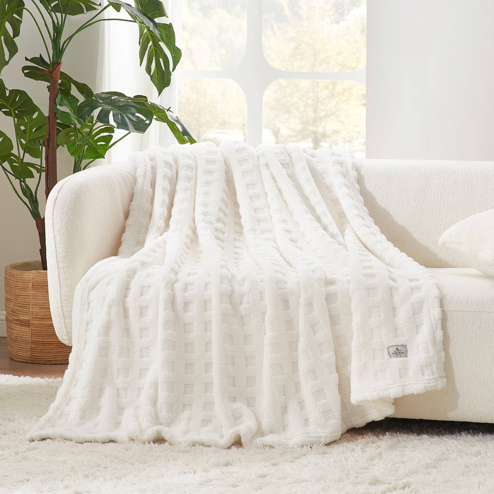 Checkered waffle shaggy sherpa throw blanket in Ivory draped over a sofa, creating a soft and cozy living space #color_Ivory