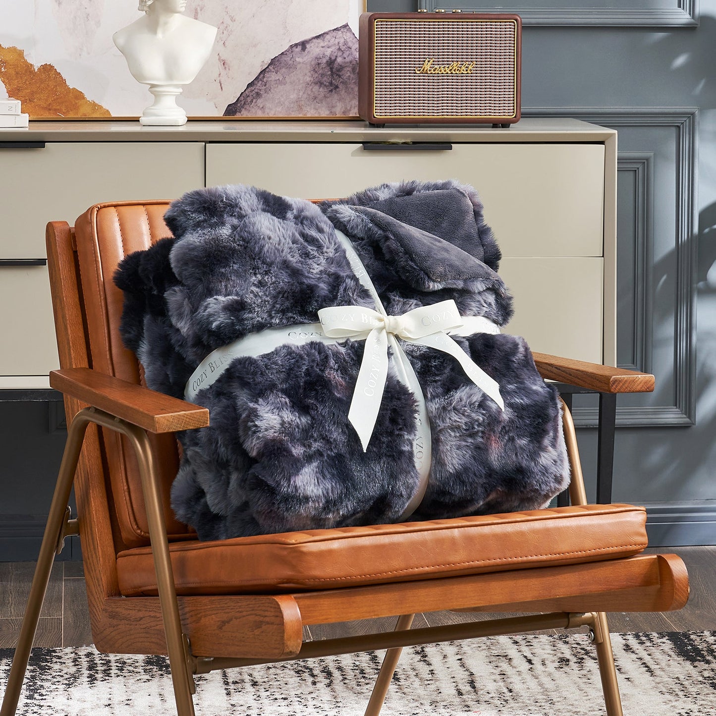 Cozy Bliss tie-dye faux fur throw blanket on an armchair #color_Tie-dye Black
