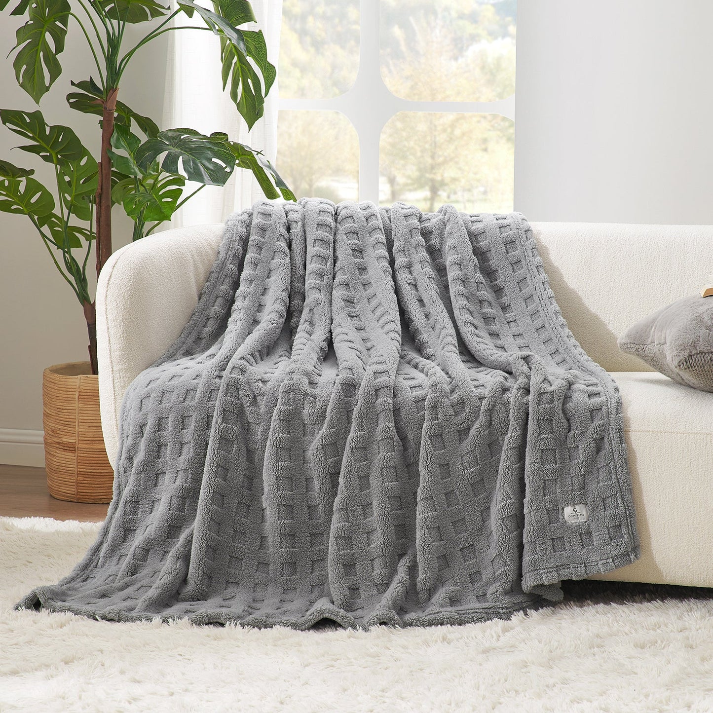 Checkered waffle shaggy sherpa throw blanket in Light Grey draped over a sofa, creating a soft and cozy living space #color_Grey