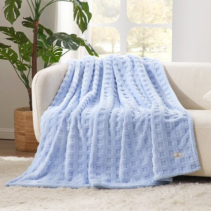 Checkered waffle shaggy sherpa throw blanket in Blue draped over a sofa, creating a soft and cozy living space #color_Cool Blue