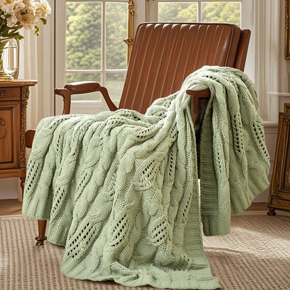 Chenille Cable Knit Throw Blanket in Sage Green front view draped over an armchair, showcasing soft chenille texture and elegant cable knit design. #color_Sage Green