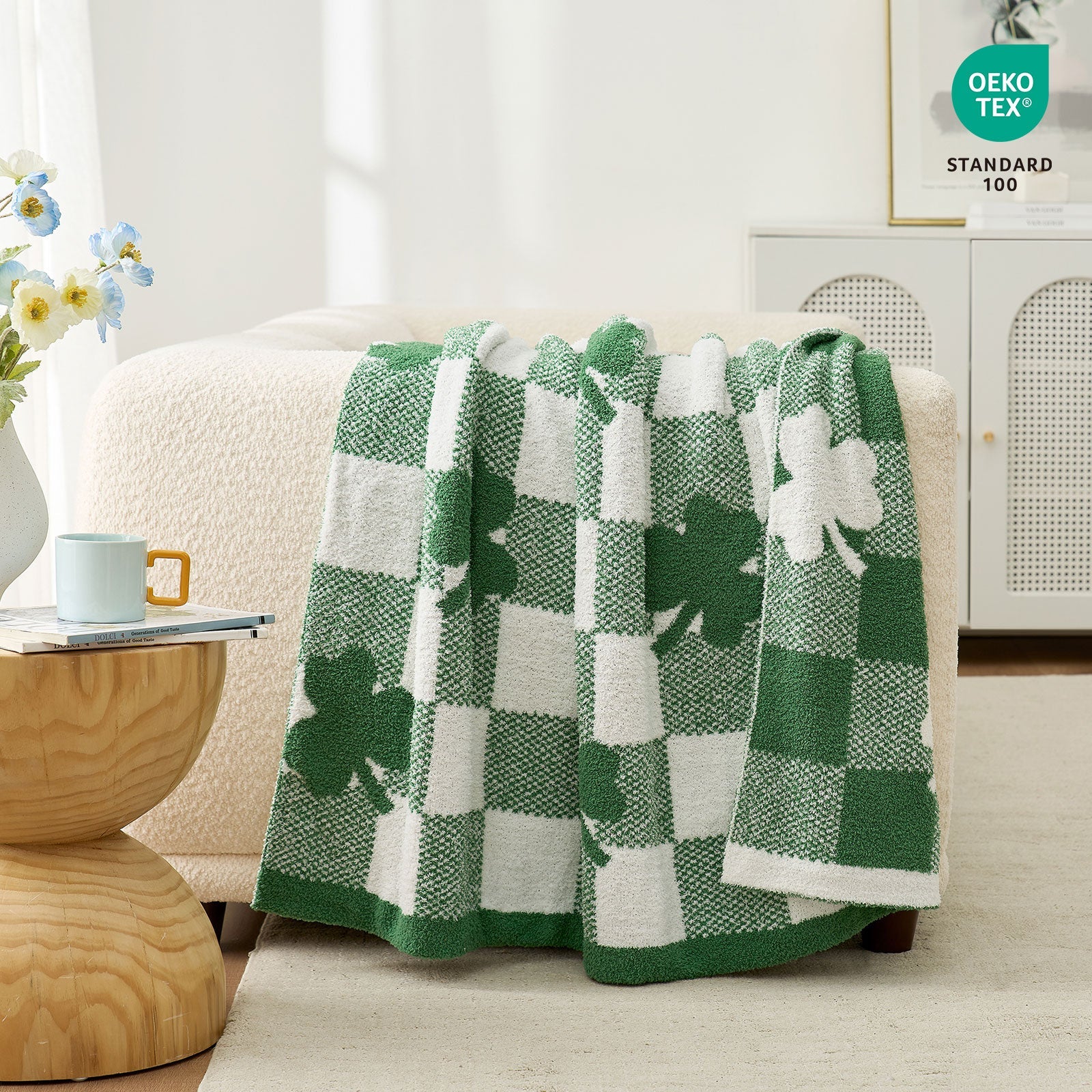 Green and white checkered blanket with shamrock design draped over a chair in a room. #color_Lucky Clover