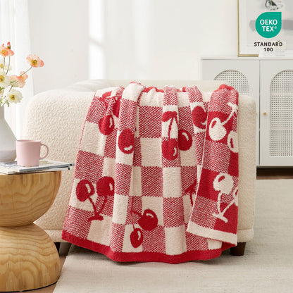 Reversible Checkered With Red Cherry Throw Blanket in Red Cherry draped over a sofa with OEKO-TEX STANDARD 100 certification, highlighting soft and safe fabric quality. #color_Red Cherry