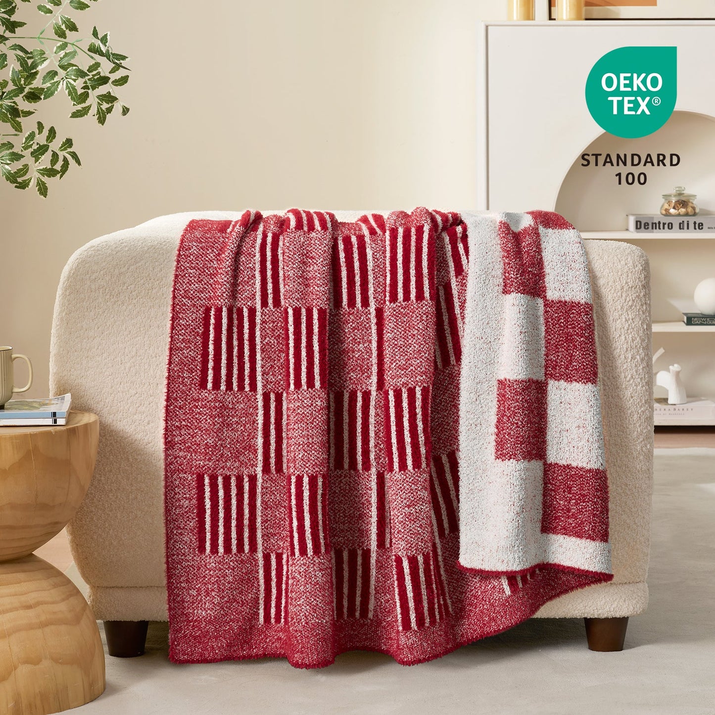 Reversible Heather Checkered Feather Yarn Throw Blanket in Red draped over a sofa, showcasing its soft texture, checkered pattern and OEKO-TEX STANDARD 100 certification. #color_Red