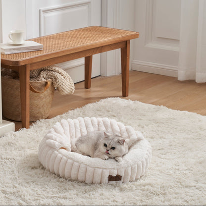 Cat lying on a fluffy white faux fur pet bed with hooded blanket in a cozy room with wooden furniture and a rug.#color_Cream Wite