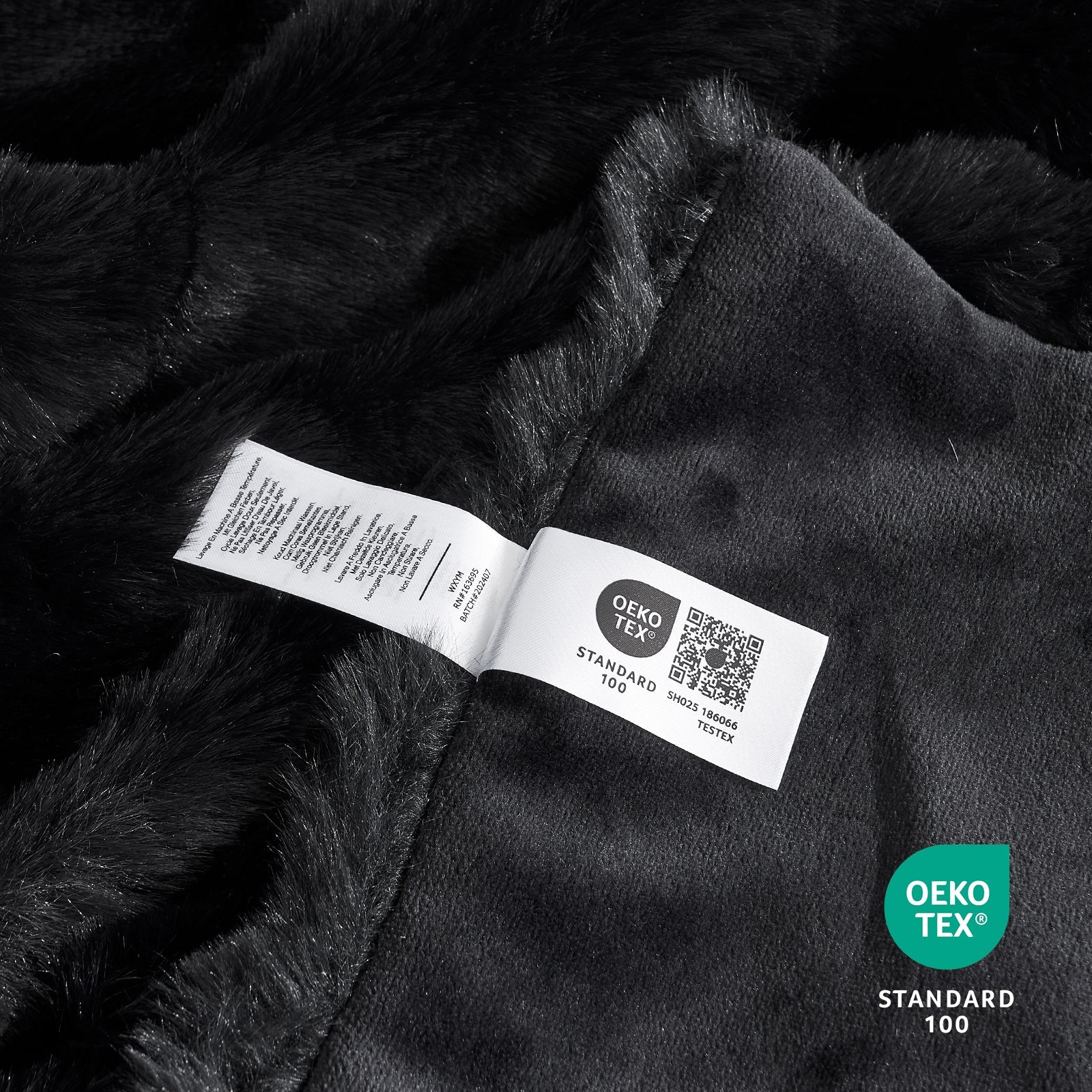 Close-up of OEKO-TEX certified faux fur black blanket fabric. #color_Black