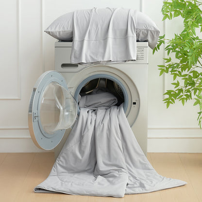 Cozy Bliss cooling comforter, easy to wash, soft and breathable, displayed in a washing machine. #Color_Light Grey
