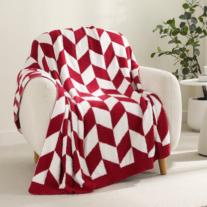 Chevron Feather Yarn Knit Throw Blanket in Red draped over an armchair, showcasing soft feather yarn texture and chevron pattern design. #color_Red