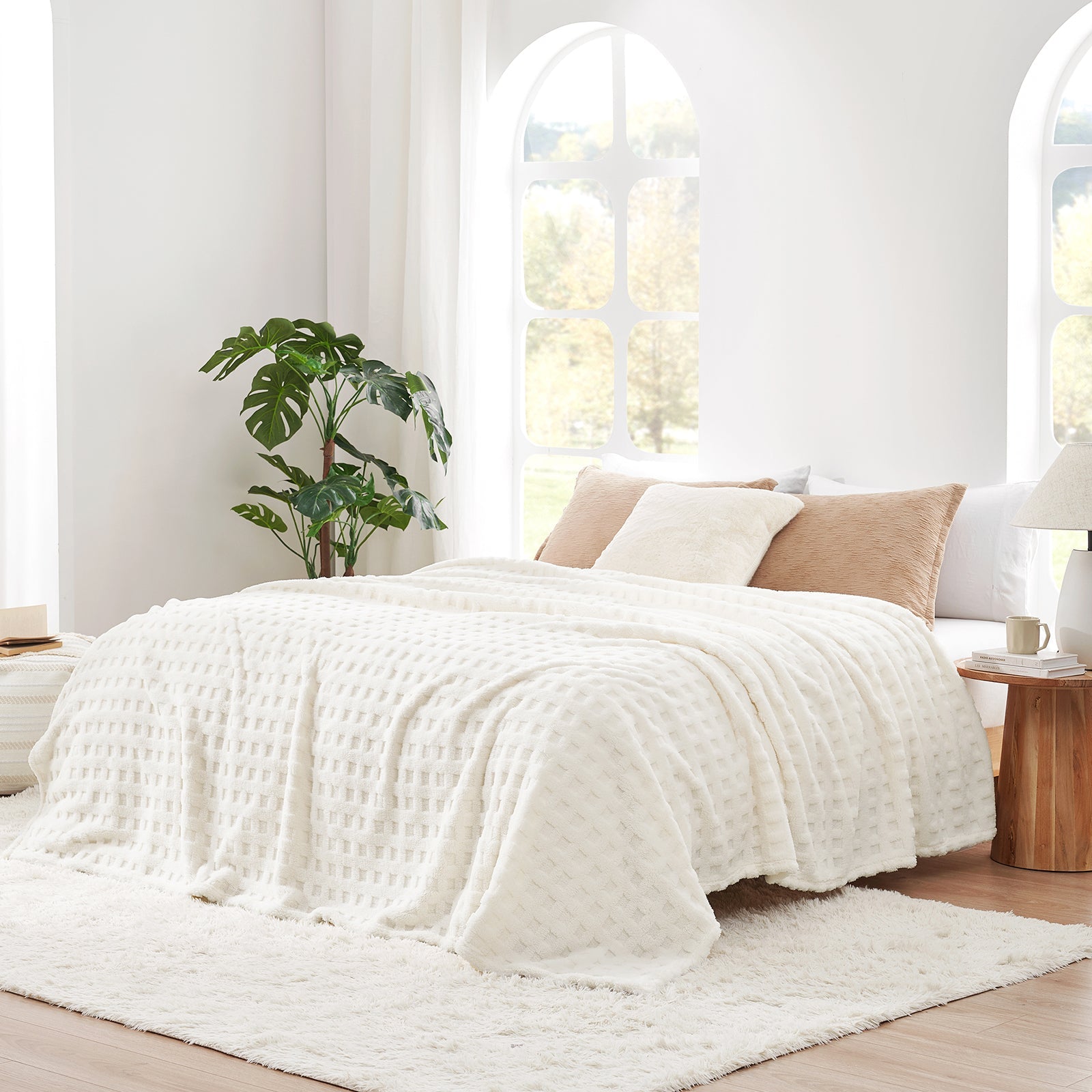 Checkered waffle shaggy sherpa throw blanket in Ivory layered on a bed, creating a warm and inviting bedroom look #color_Ivory