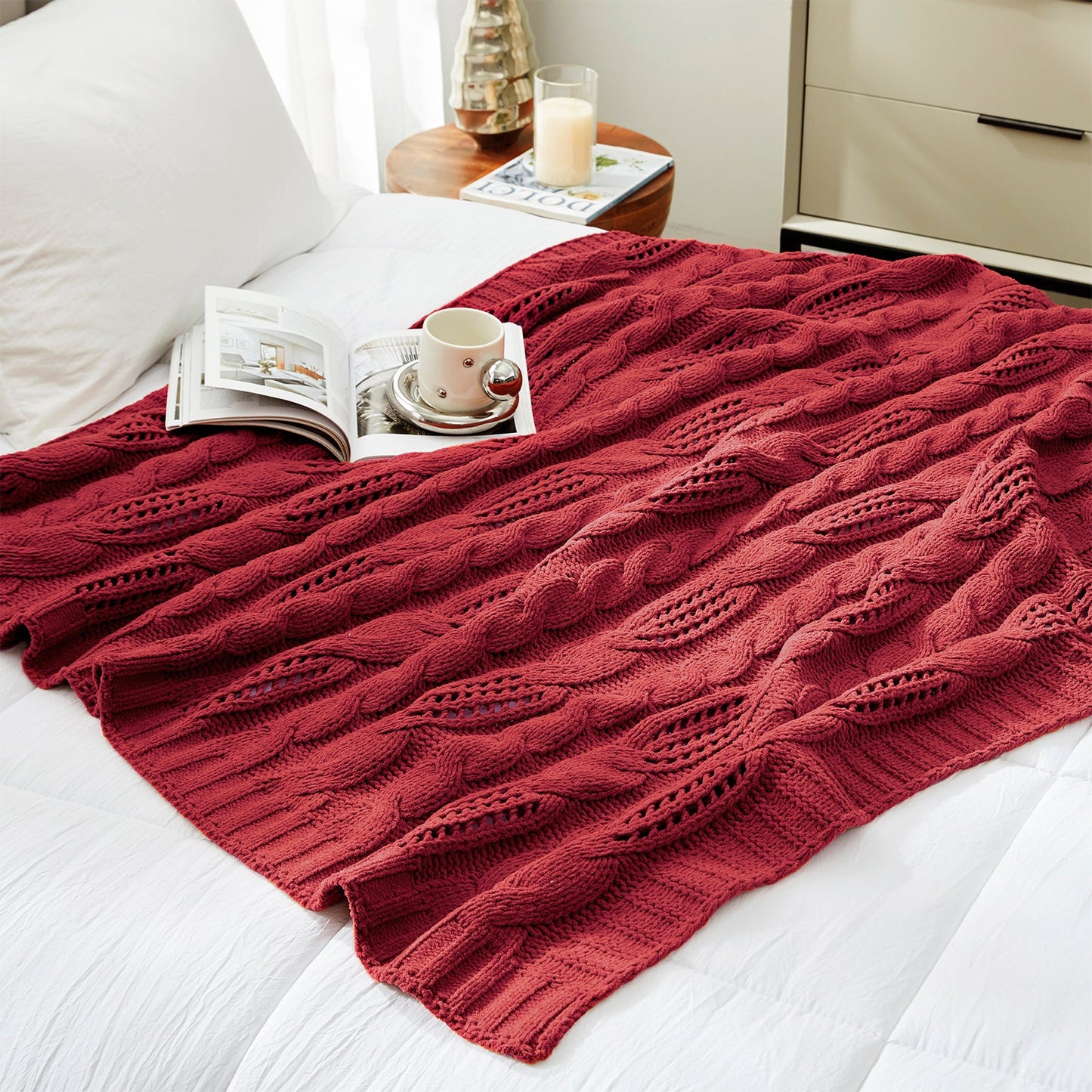Chenille Cable Knit Throw Blanket in Red styled on a bed in a modern bedroom, adding warmth and a bold cozy look. #color_Red