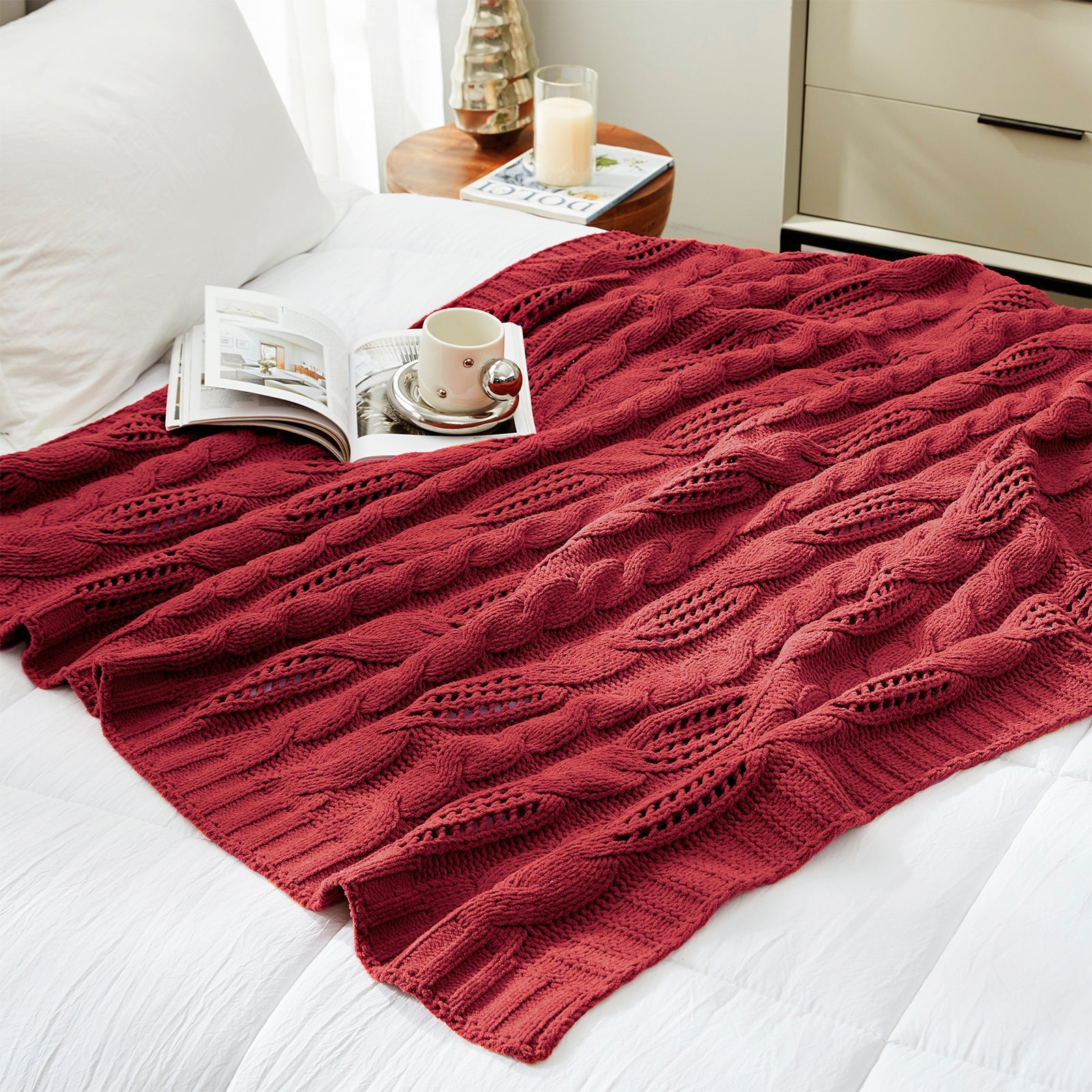 Chenille Cable Knit Throw Blanket in Red styled on a bed in a modern bedroom, adding warmth and a bold cozy look. #color_Red
