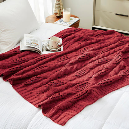 Chenille Cable Knit Throw Blanket in Red styled on a bed in a modern bedroom, adding warmth and a bold cozy look. #color_Red