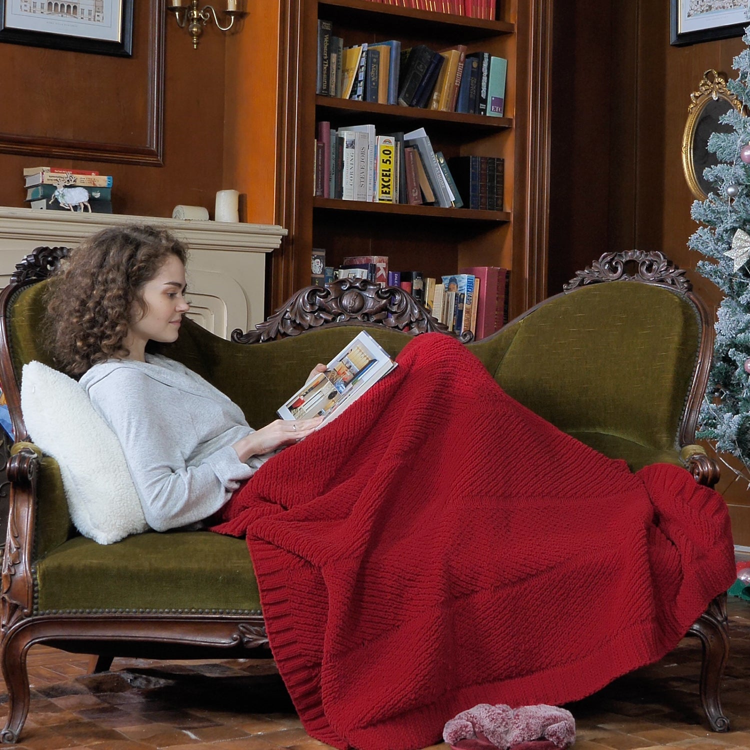 Woman relaxing on a sofa with a Chevron Chenille Knit Throw Blanket in red, ideal for cozy moments. #color_Red