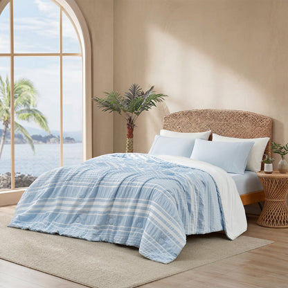 Cozy Bliss cationic dyed striped seersucker cooling comforter in Sky Blue layered on a bed #color_Sky Blue