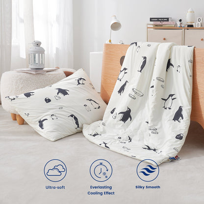 Penguin-patterned pillow and comforter set on a bed with product features displayed.#color_Antarctic Penguin